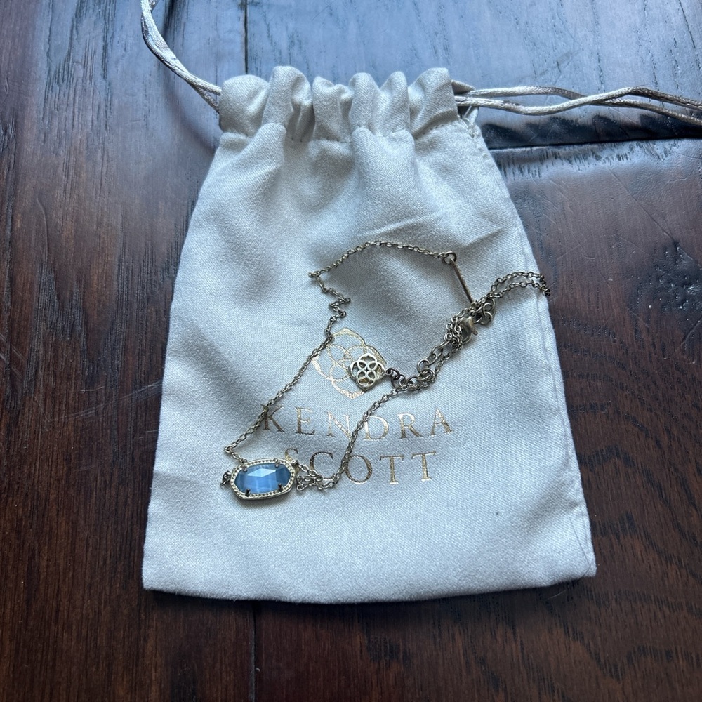 Gold Kendra Scott with blue jewel